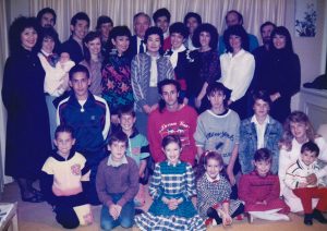A group photograph of Gordon and Cherry Parker, their children, and their children's children, taken in 1988. Cherry stands in the centre, Gordon stands behind her.