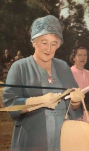Mabel Venn Parker dressed in a blue outfit, cuts a ribbon to open H.E. Parker Reserve in Heathmont, named for her late husband, Harry Parker.
